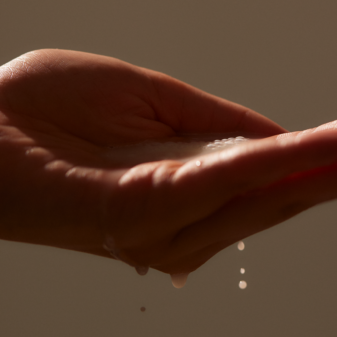 Close up of hand holding Blue Instant Deep Hydration Essence I