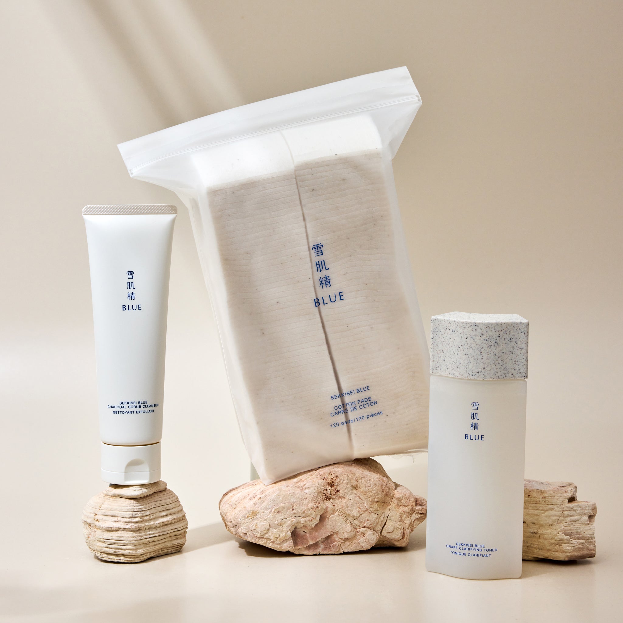Skincare set featuring Blue Cotton Pads, Blue Grape Clarifying Toner, and Blue Charcoal Scrub Cleanser